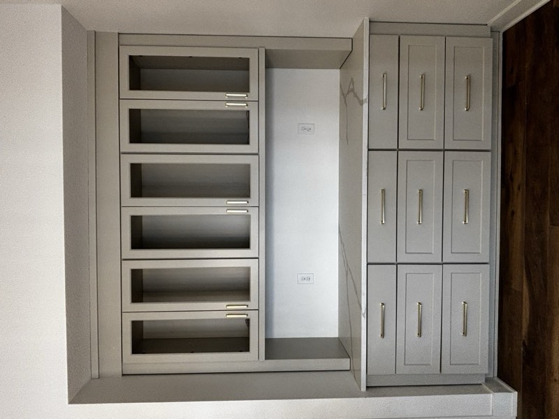 Built-in hutch with glass-front upper cabinets, quartz counter and nine deep drawers